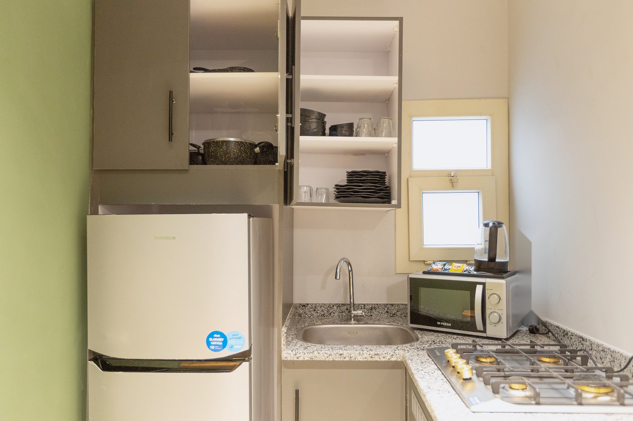 Travelholic Green Light 2BR with Balcony | Lotus 103 — Full Kitchen in Travelholic Residence near Mivida. Unit 103., Egypt — photo 2