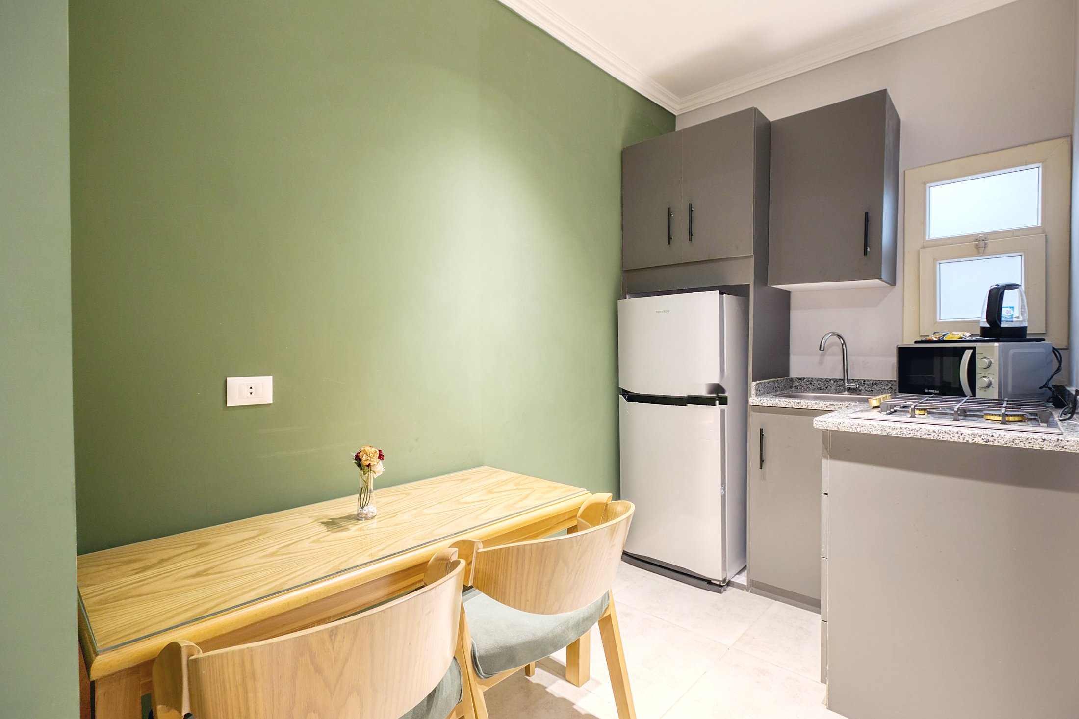 Travelholic Green Light 2BR with Balcony | Lotus 203 — Full Kitchen in Travelholic Residence near Mivida. Unit 203., Egypt