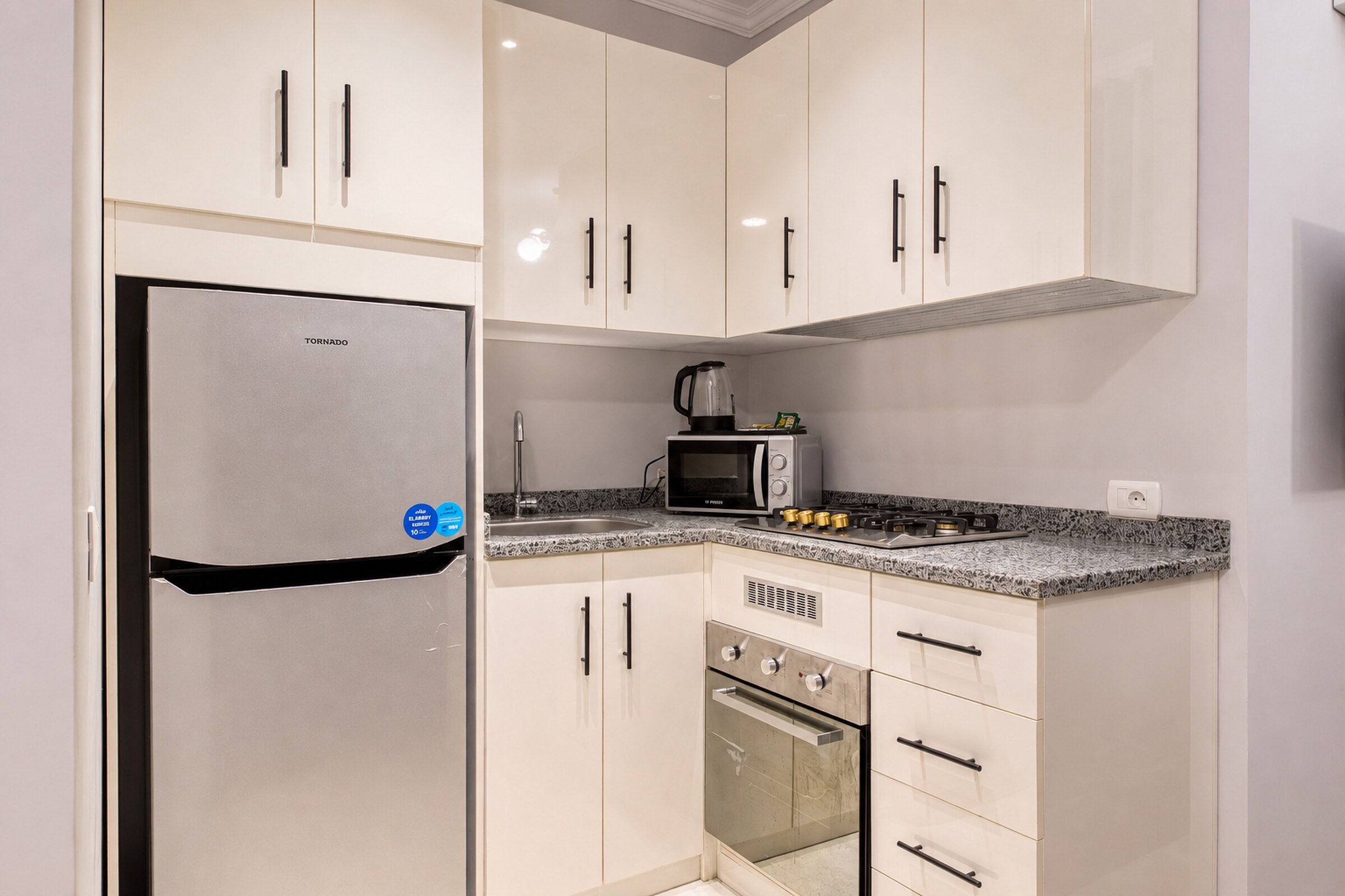 Travelholic Navy Nest 2BR Apartment | Lotus 306 — Full Kitchen in Travelholic Residence near Mivida. Unit 306., Egypt