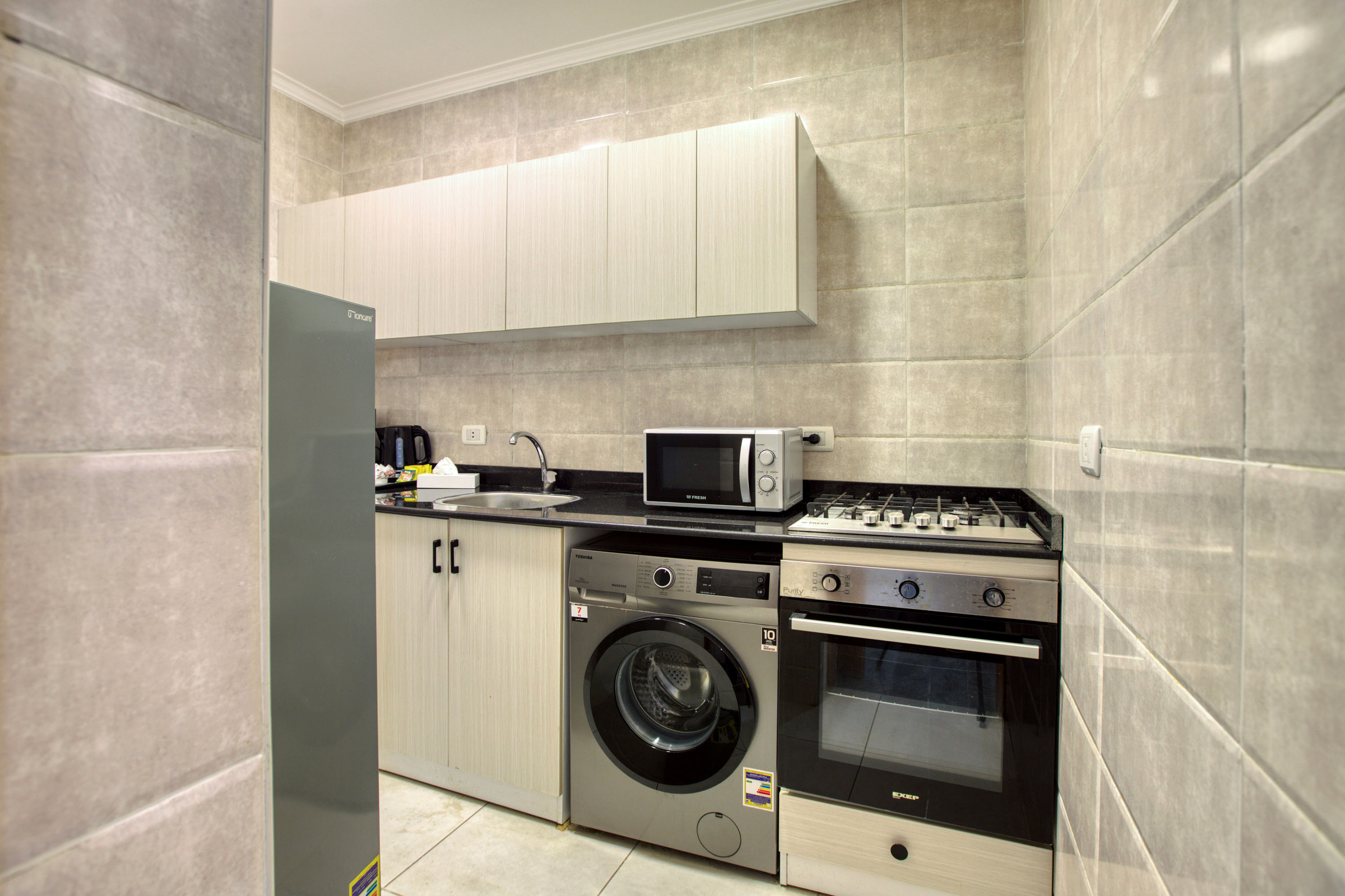 Travelholic Sunlit 2BR Apartment near AUC | AUC 404 — Full Kitchen in Travelholic AUC Residence. Unit 404., Egypt