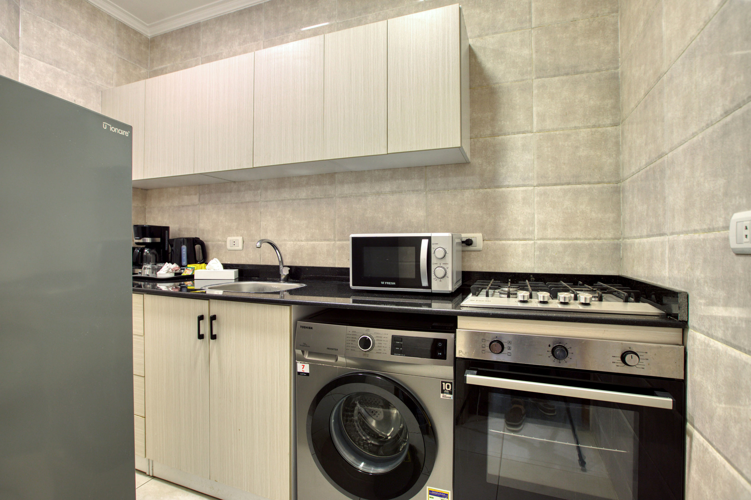 Travelholic Sunlit 2BR Apartment near AUC | AUC 304 — Full Kitchen in Travelholic AUC Residence. Unit 304., Egypt