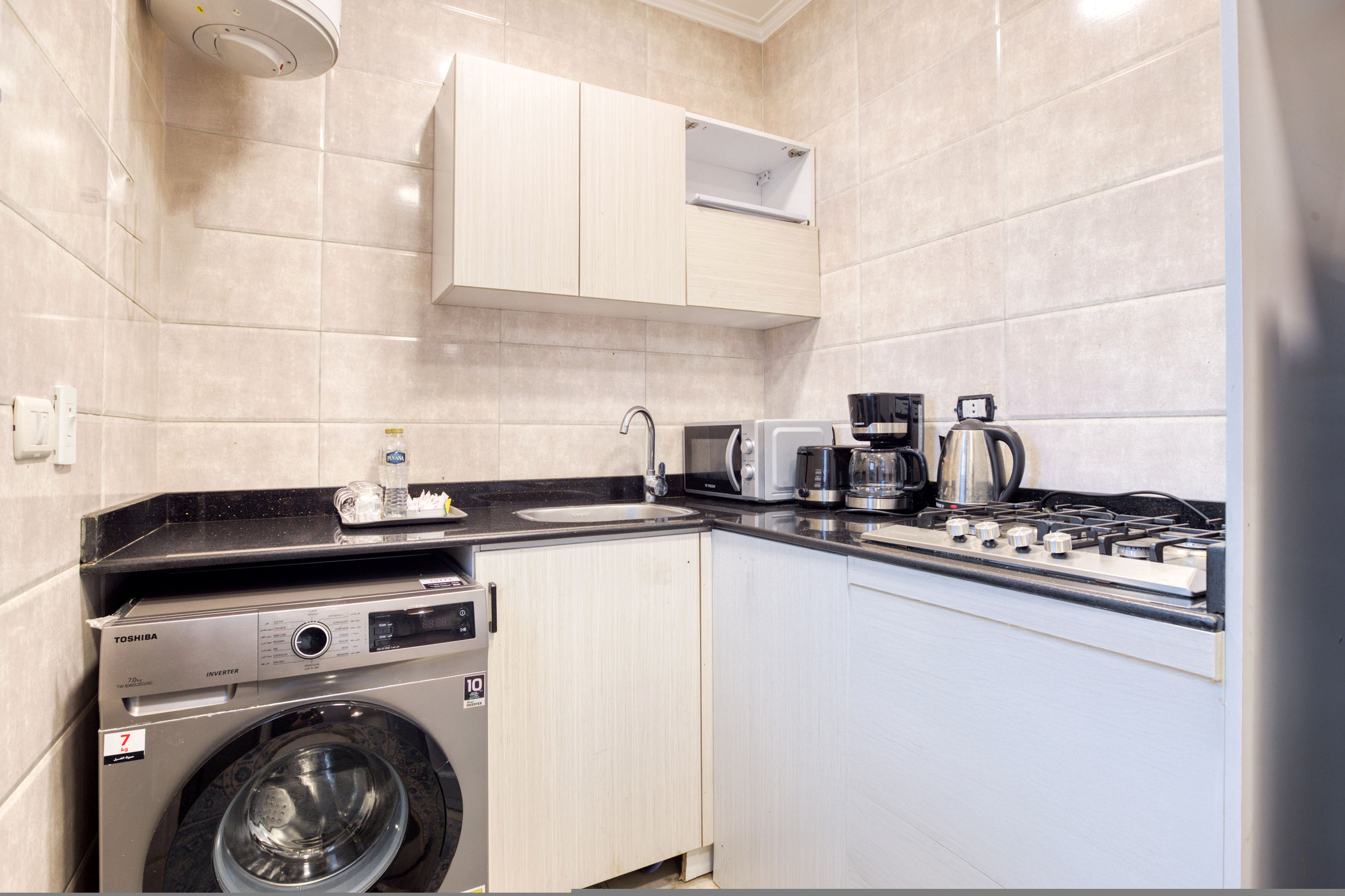 Travelholic Vista 3BR Apartment near AUC | AUC 101 — Full Kitchen in Travelholic AUC Residence. Unit 101., Egypt