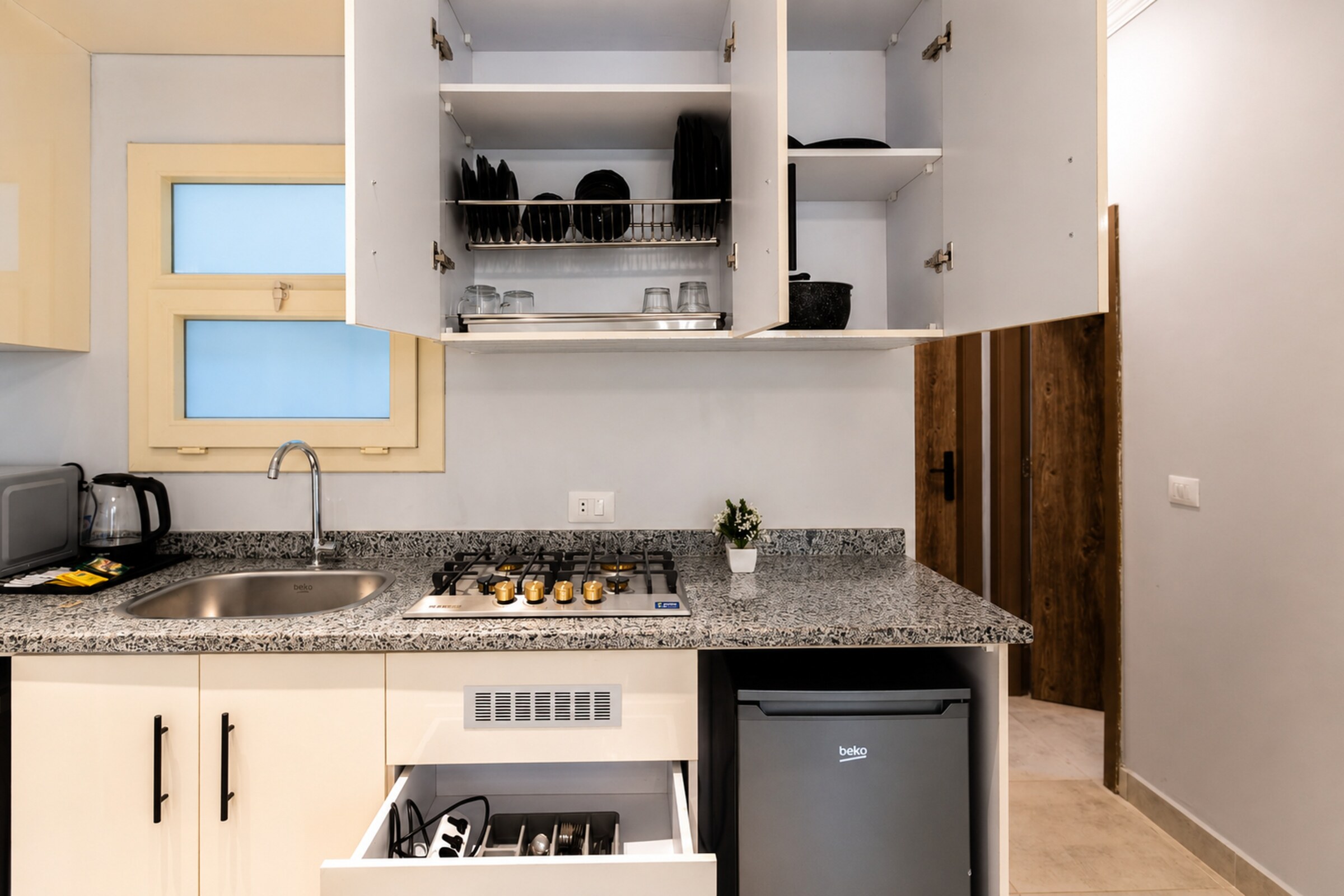 Travelholic Calm Corner 1BR with Balcony | Lotus 304 — Full Kitchen in Travelholic Residence near Mivida. Unit 304., Egypt